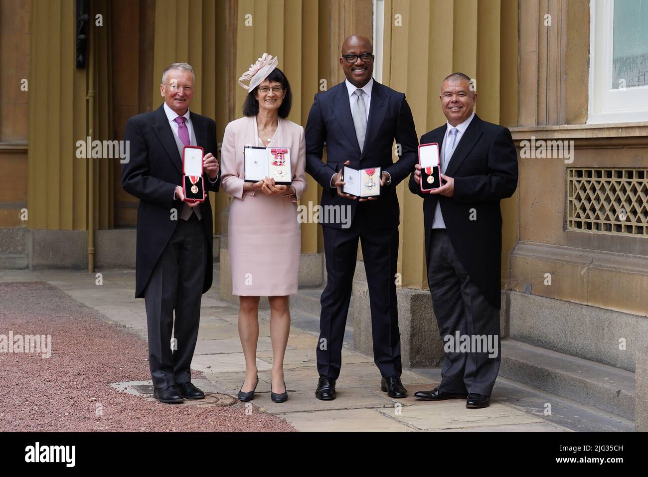 (left to right) Sir Paul Nurse, Companion of Honour, Professor Dame Jennifer Harries, Dame Commander of the British Empire, Professor Kevin Fenton CBE, and Professor Sir Jonathan Nguyen-Van-Tam, Knight Bachelor, with their honours following an investiture ceremony at Buckingham Palace in London. Picture date: Thursday July 7, 2022. Stock Photo