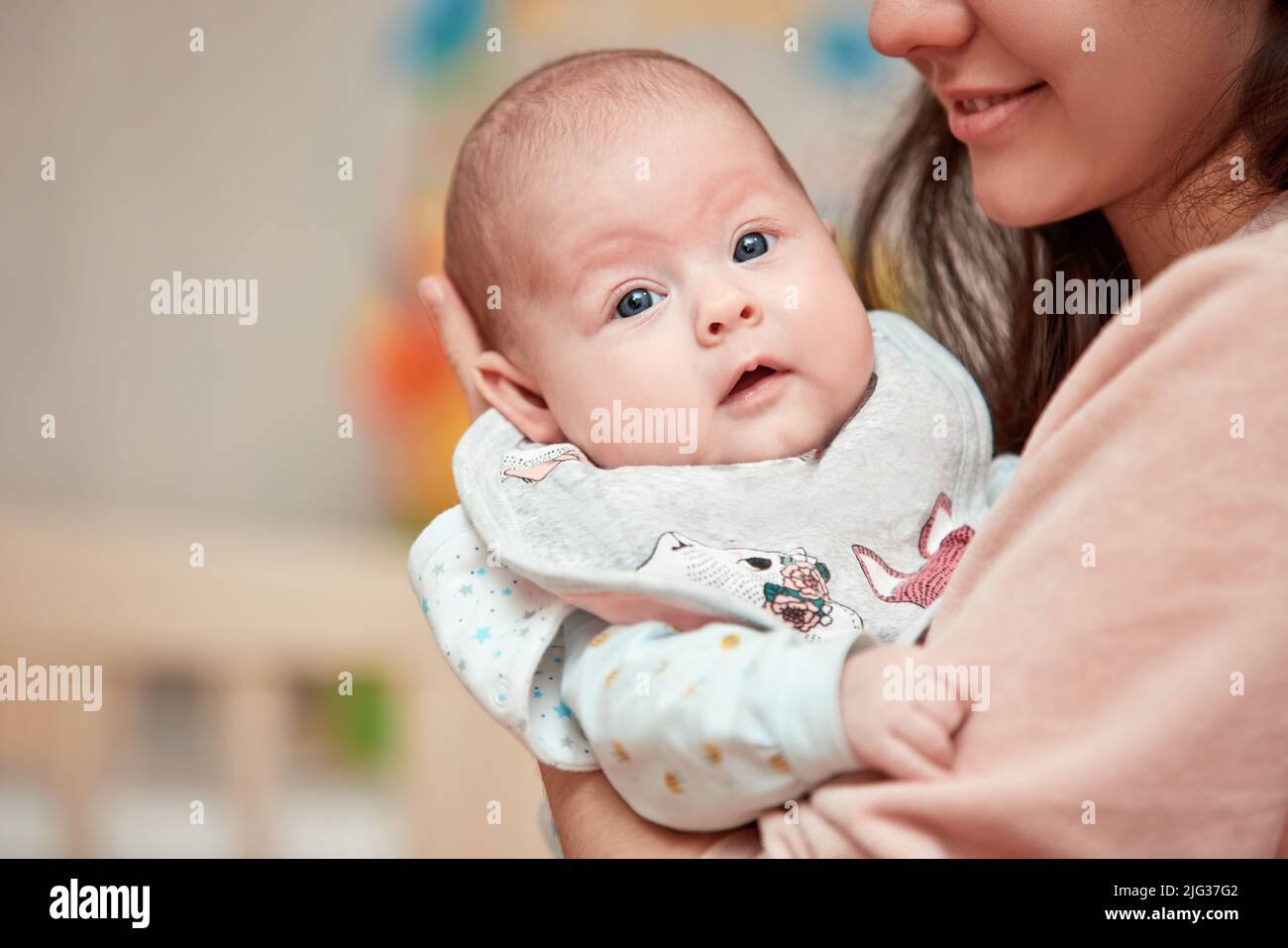 Young mother holding adorable newborn baby Stock Photo - Alamy