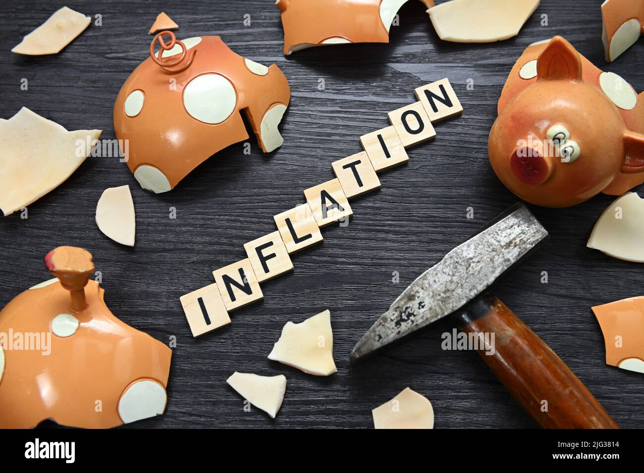 Broken Piggy Bank And Letter Tiles, Inflation Stock Photo