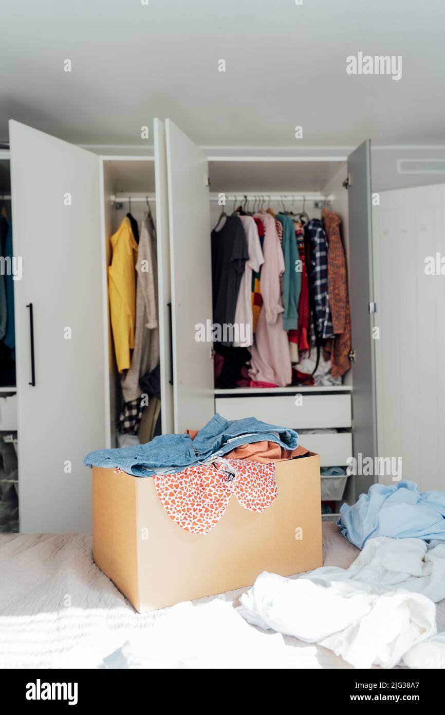 A cardboard box of selected clothes for donating to a Charity shop