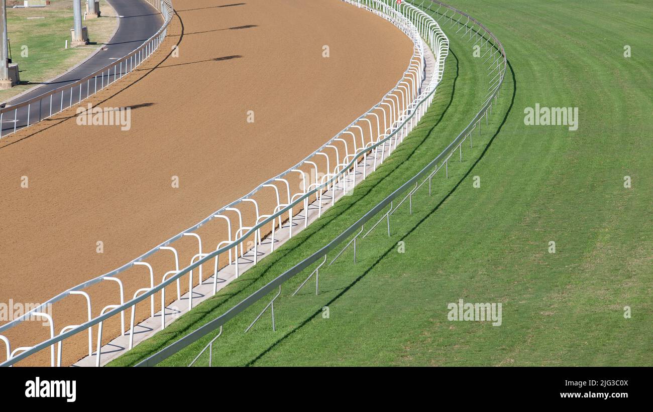 Horse racing closeup  race tracks grass turf and sand Poly. Stock Photo