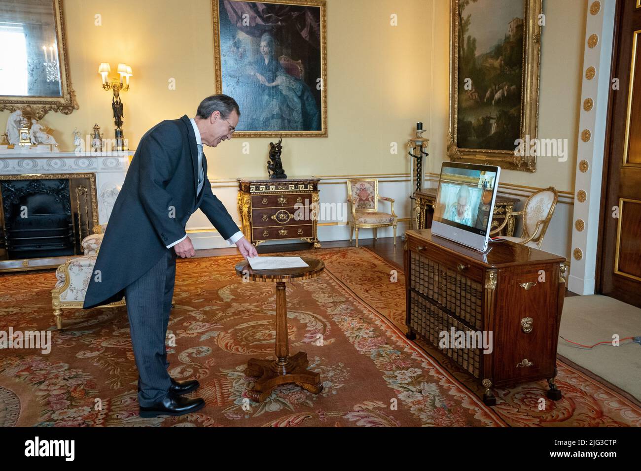 Queen Elizabeth II, in residence at Windsor Castle, appears on a screen