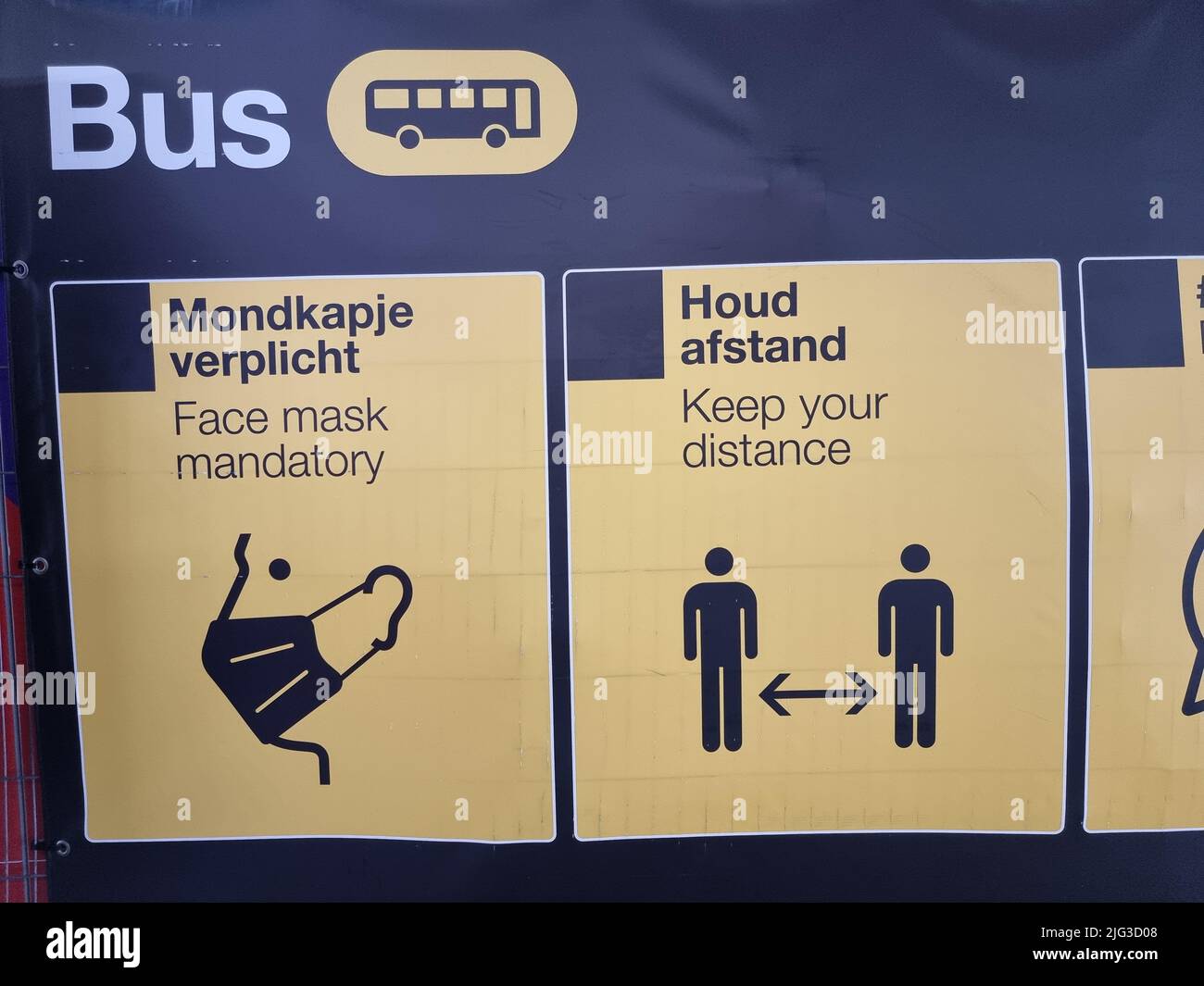 Dutch signs depicting corona measures (keep distance, face mask mandatory, etc.) at the bus station of Eindhoven Airport in the Netherlands Stock Photo