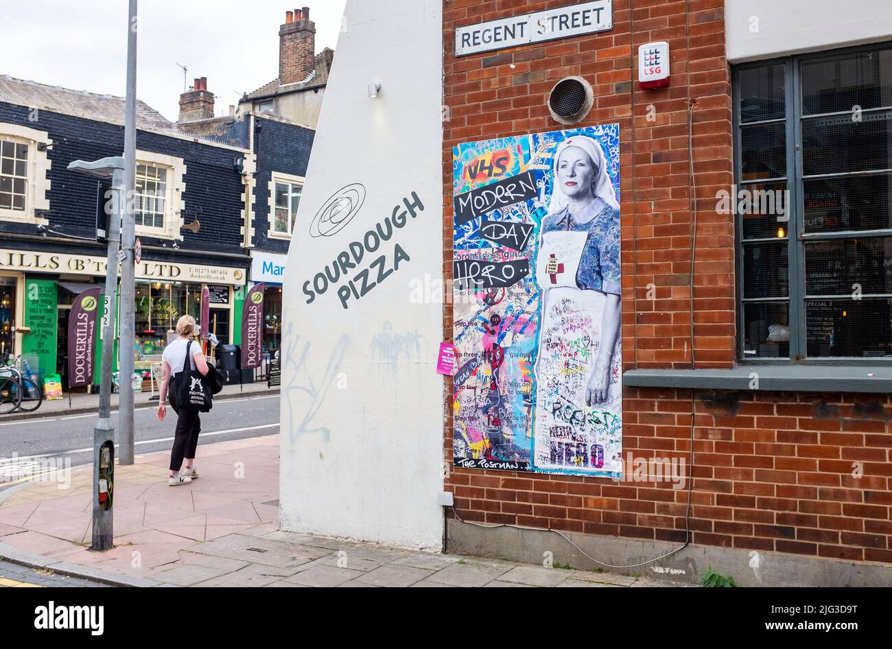 A mural by The Postman depicting an NHS nurse with the title 'Modern Day Hero' on the corner of Regent Street and Church Road in Brighton, Sussex , England , UK -  The Postman Art are a Brighton based street art duo brightening up public spots locally and internationally Stock Photo