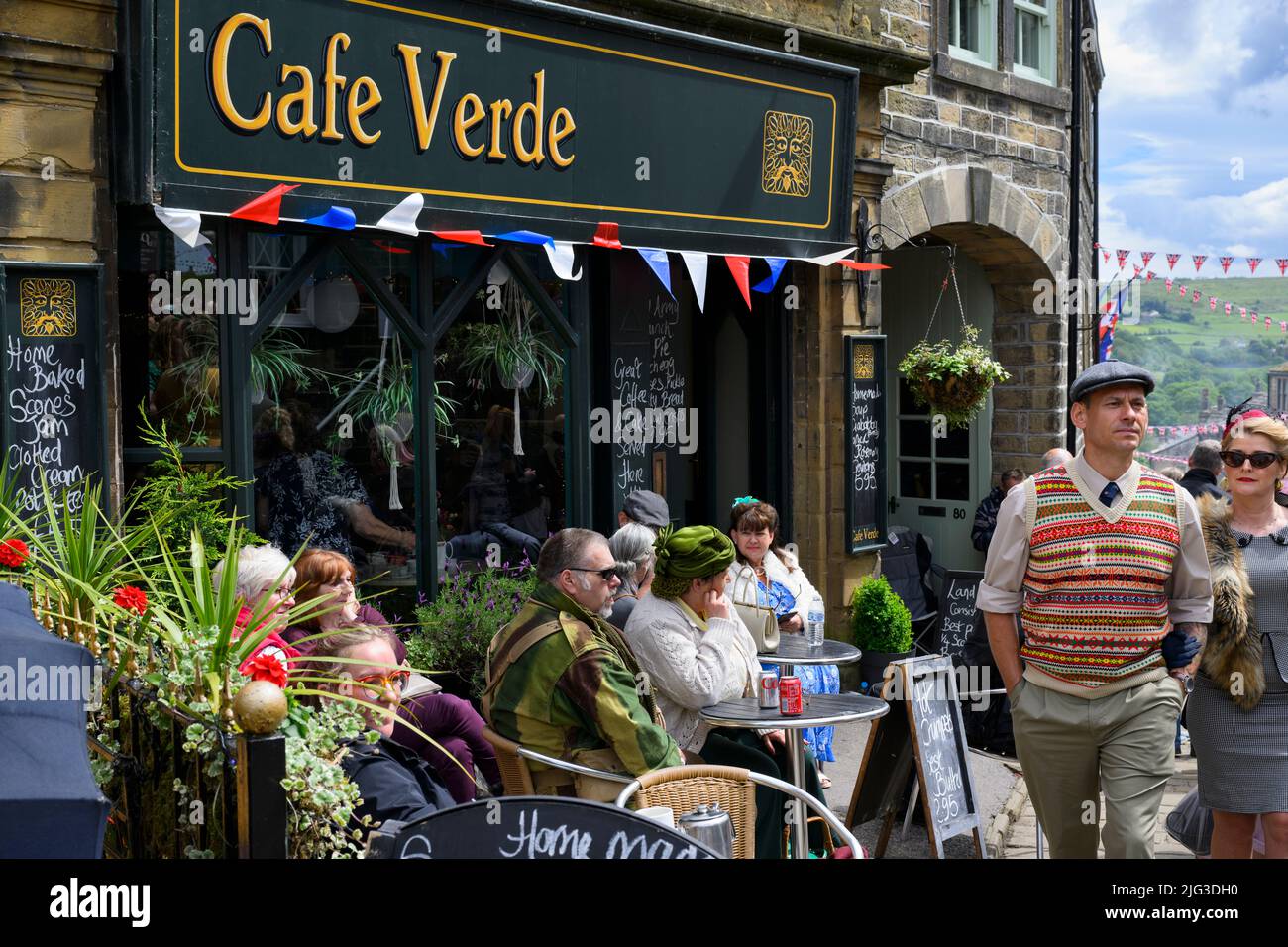 Haworth 1940 re-enactment living history event (re-enactors nostalgic day-out, tables & bunting, Cafe Verde) - Main Street, Yorkshire, England, UK. Stock Photo