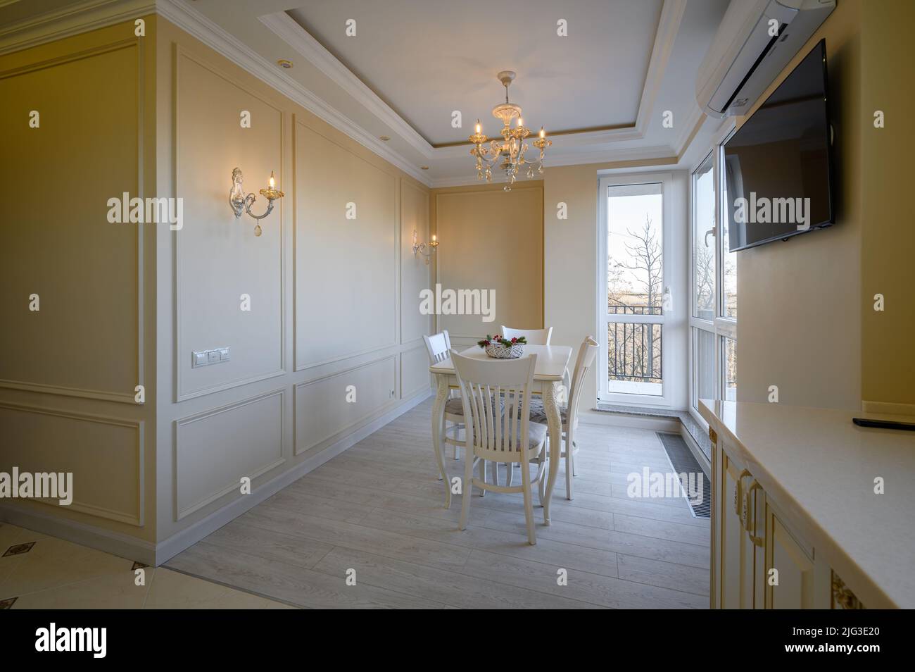 Classic white and beige large kitchen with dining table in studio