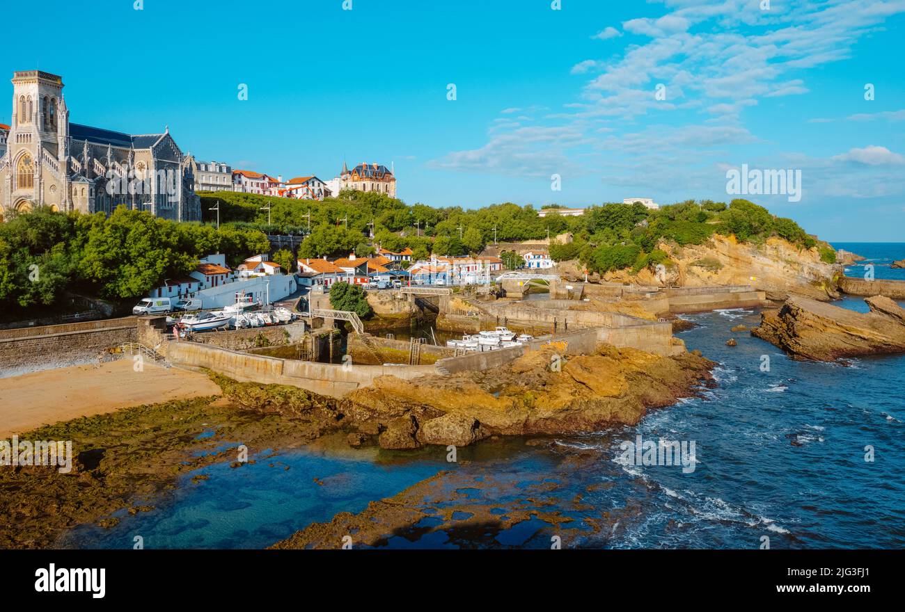 Biarritz, France - June 24, 2022: A view over the Port des Pecheurs, the fishermen port, in Biarritz, France, and the Sainte-Eugenie Church in the bac Stock Photo