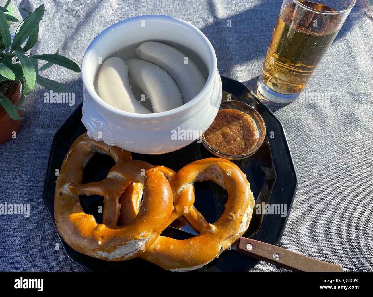 traditional German lunch of pretzel bread and white sausage soup Stock Photo