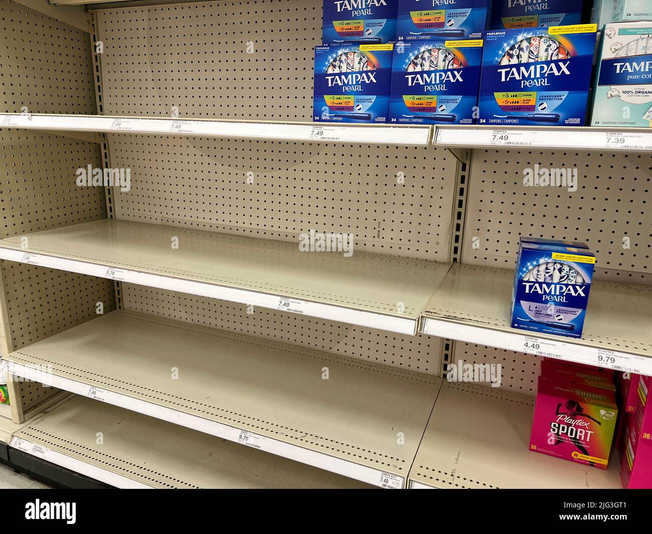 Empty space on shelves at a Target store show the current tampon