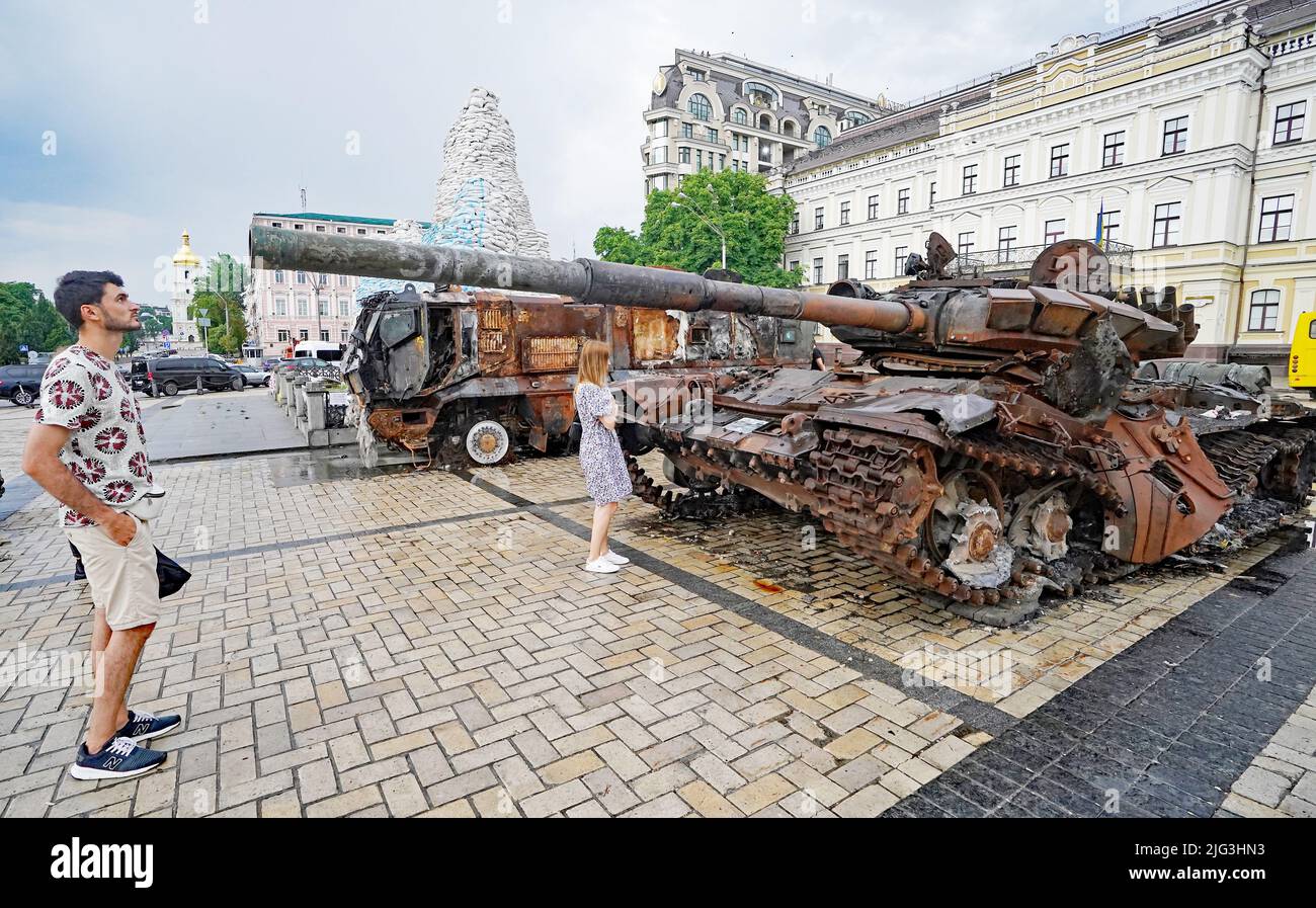 A man looks down the barrel of a destroyed Russian tank displayed St Michael's Square, Kyiv Ukriaine. Picture date: Thursday July 7, 2022. Stock Photo