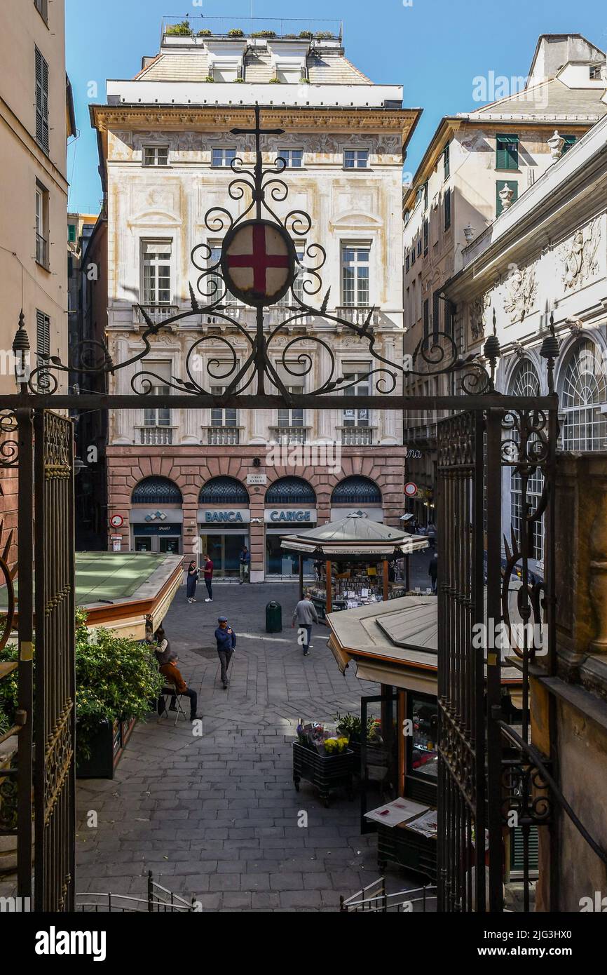 High-angle view of Piazza Banchi from the iron gate of the Church of San Pietro in Banchi (1585) in the historic centre of Genoa, Liguria, Italy Stock Photo
