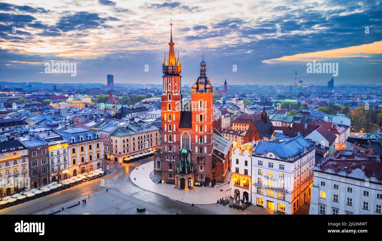 Krakow, Poland. Bazylika Mariacka church and Cloth Hall on Main Square Cracovia, illuminated in the night Stock Photo