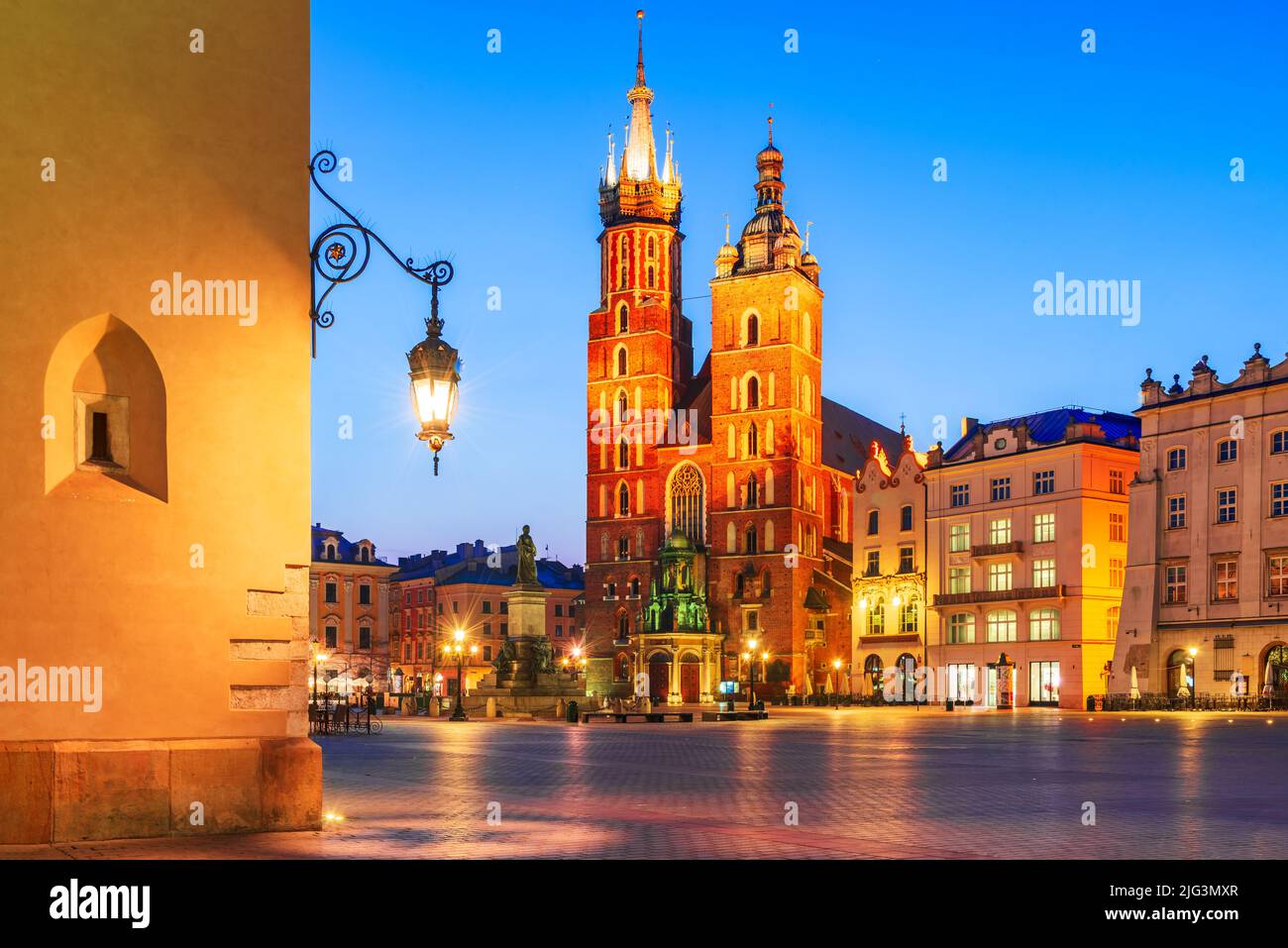 Krakow, Poland. Bazylika Mariacka church and Cloth Hall on Main Square Cracovia, illuminated in the night Stock Photo