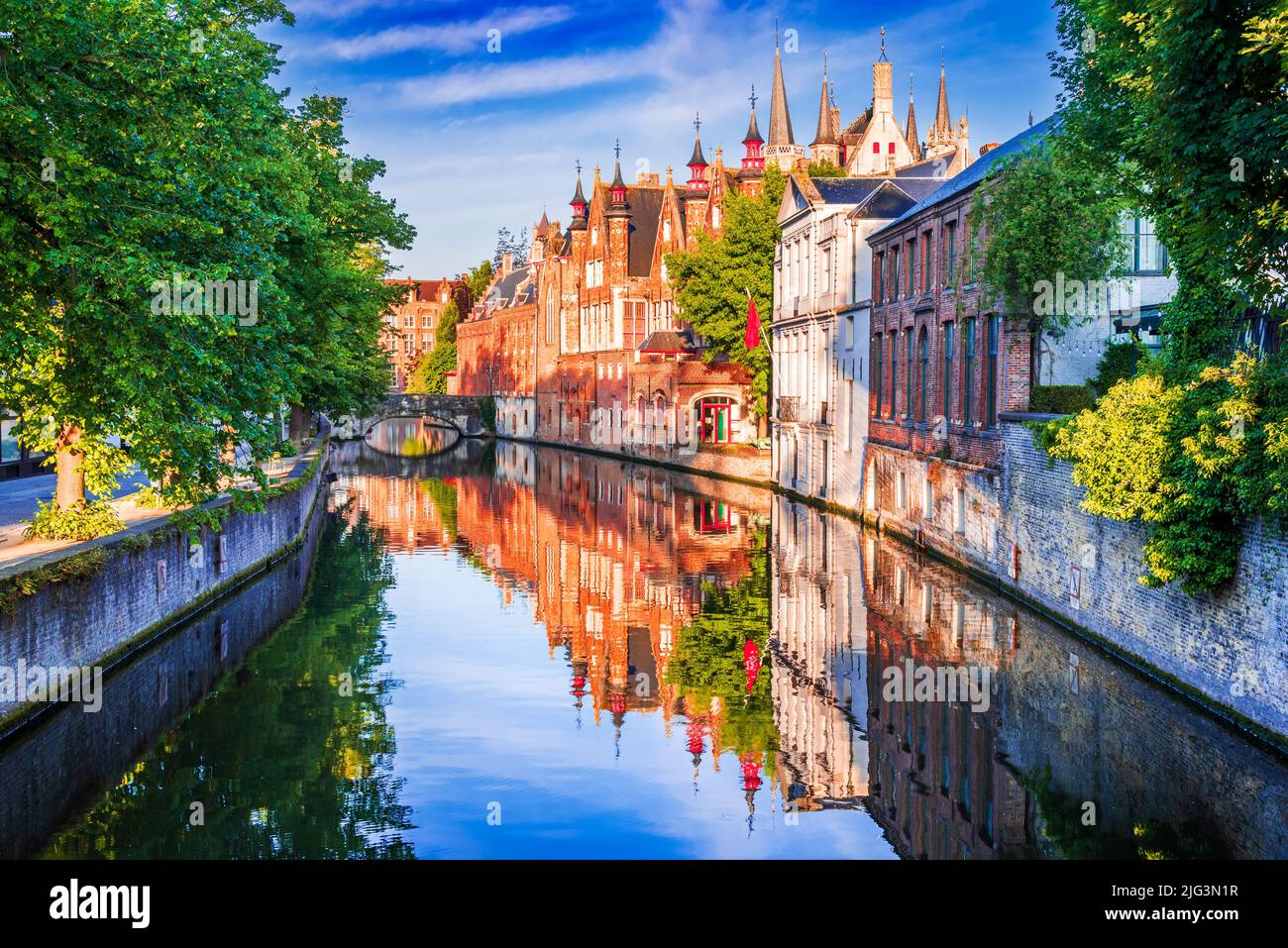 Bruges, Belgium. Panoramic view of the historic city center of Brugge with Groenerei Canal in beautiful golden morning light at sunrise, province of W Stock Photo
