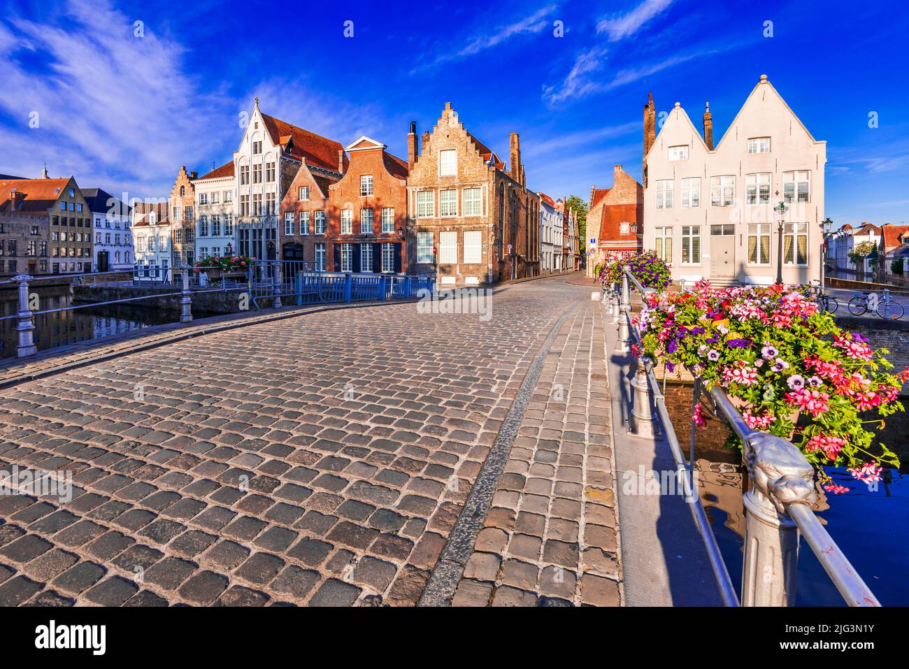 Bruges, Belgium. Sunny landscape with beautiful houses on Spiegelrei Canal, famous Flanders landmark. Stock Photo