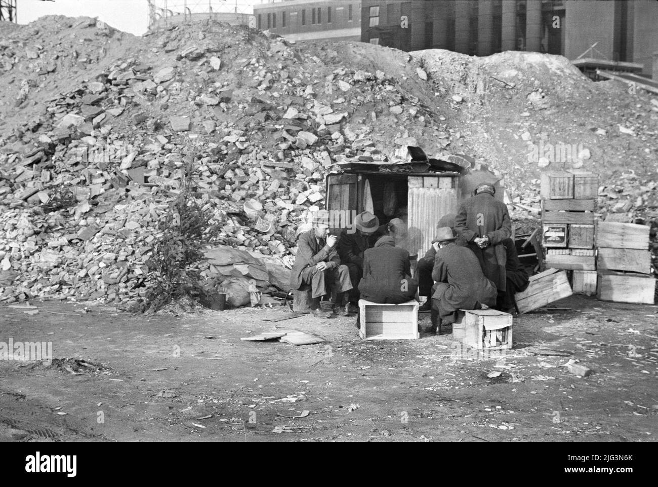 Unemployed Workers in front of Shack next to pile of rubble, East 12th Street, New York City, New York, USA, Russell Lee, U.S. Office of War Information/U.S. Farm Security Administration, January 1938 Stock Photo