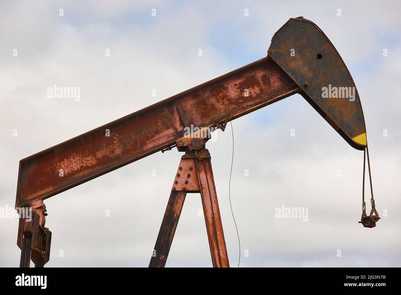 Rusty oil pumping machine. Pump jack in Ayoluengo, Burgos. Spain Stock Photo
