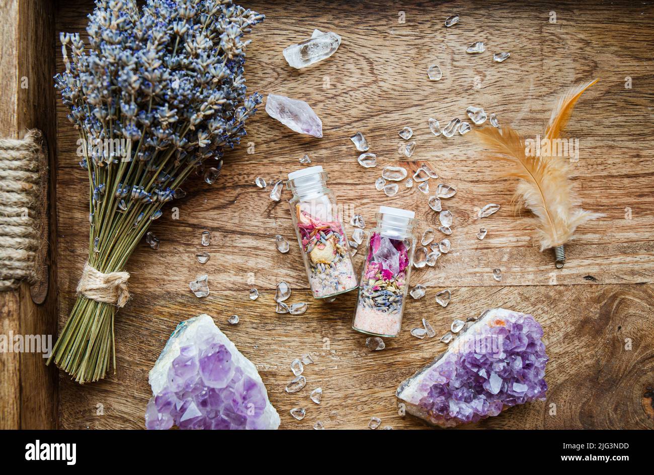 Homemade spell jar bottles with good intentions for home protection and inner balance. Filled with Himalayan rock salt, dried herbs flowers. Stock Photo