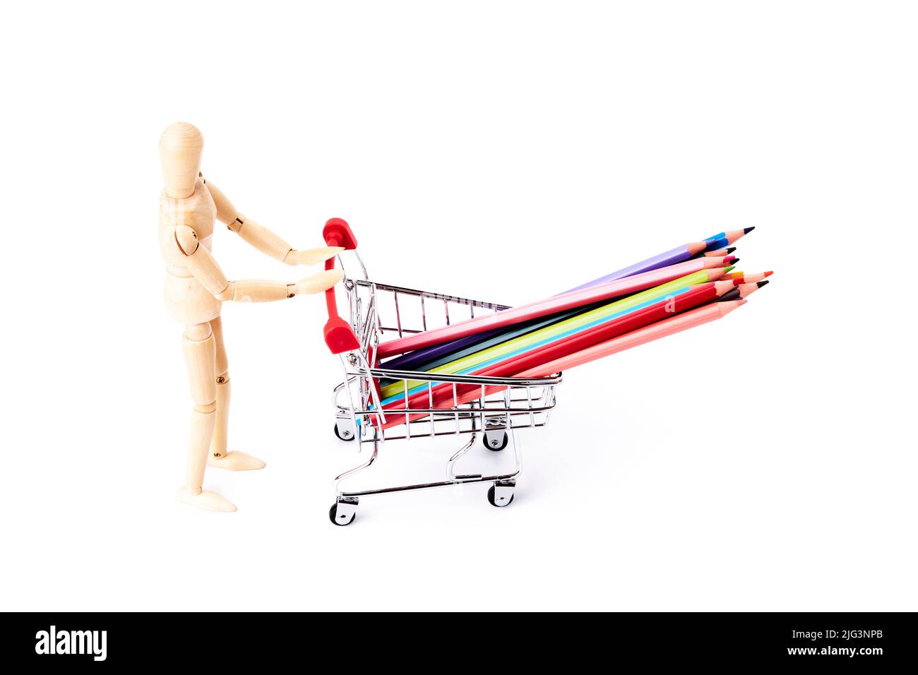 Dummy pushing a shopping cart with some multi-colored pencils. Art school concept. Studio concept Stock Photo