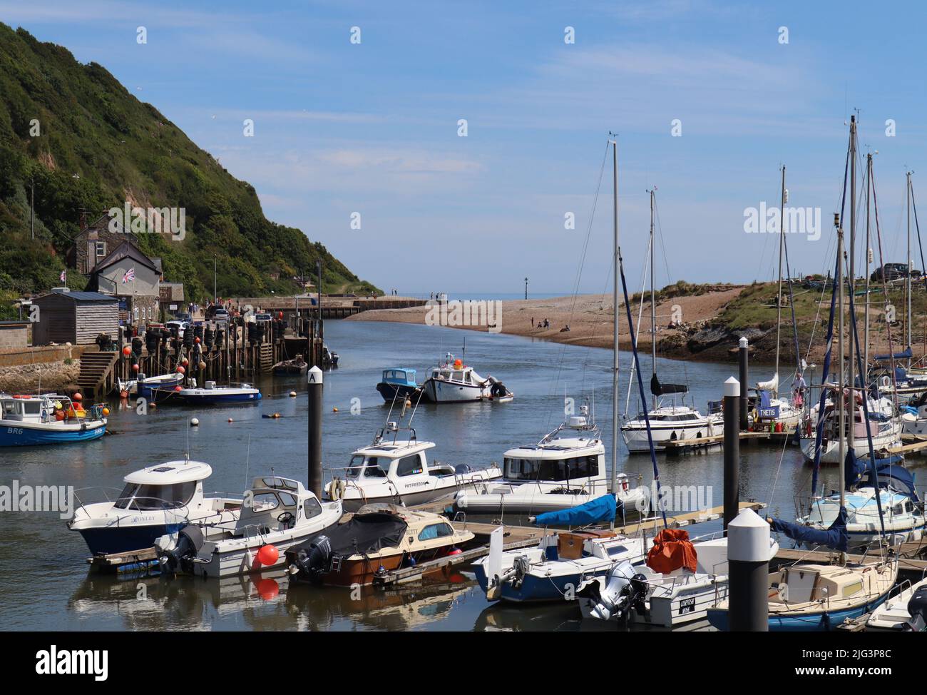 AXMOUTH, DEVON,ENGLAND - JULY 12TH 2020: Yachts and other boats in the marina at Axmouth on a beautiful sunny summers day looking south towards the se Stock Photo