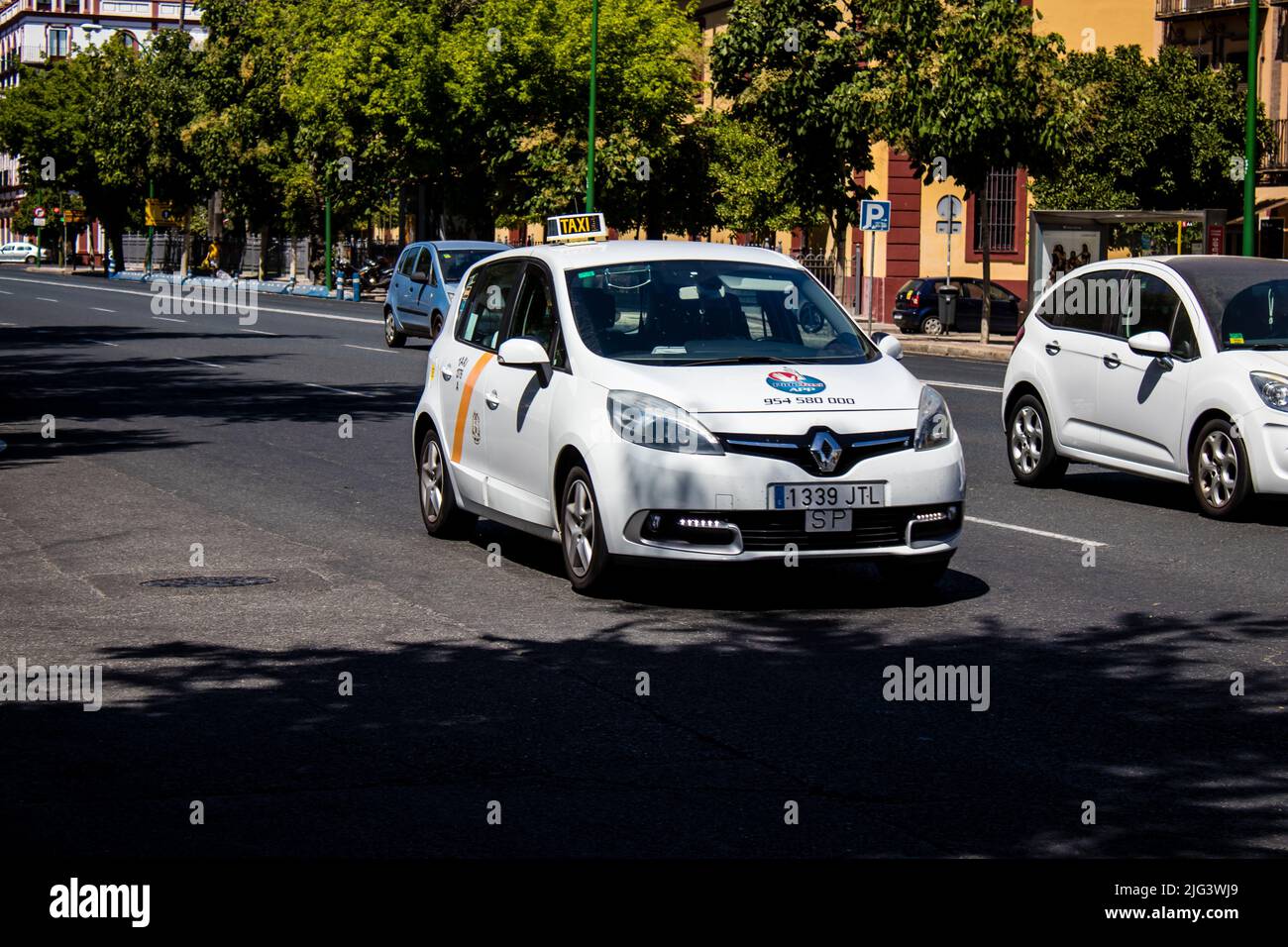 Seville, Spain July 04, 2022 Taxi driving through the streets of