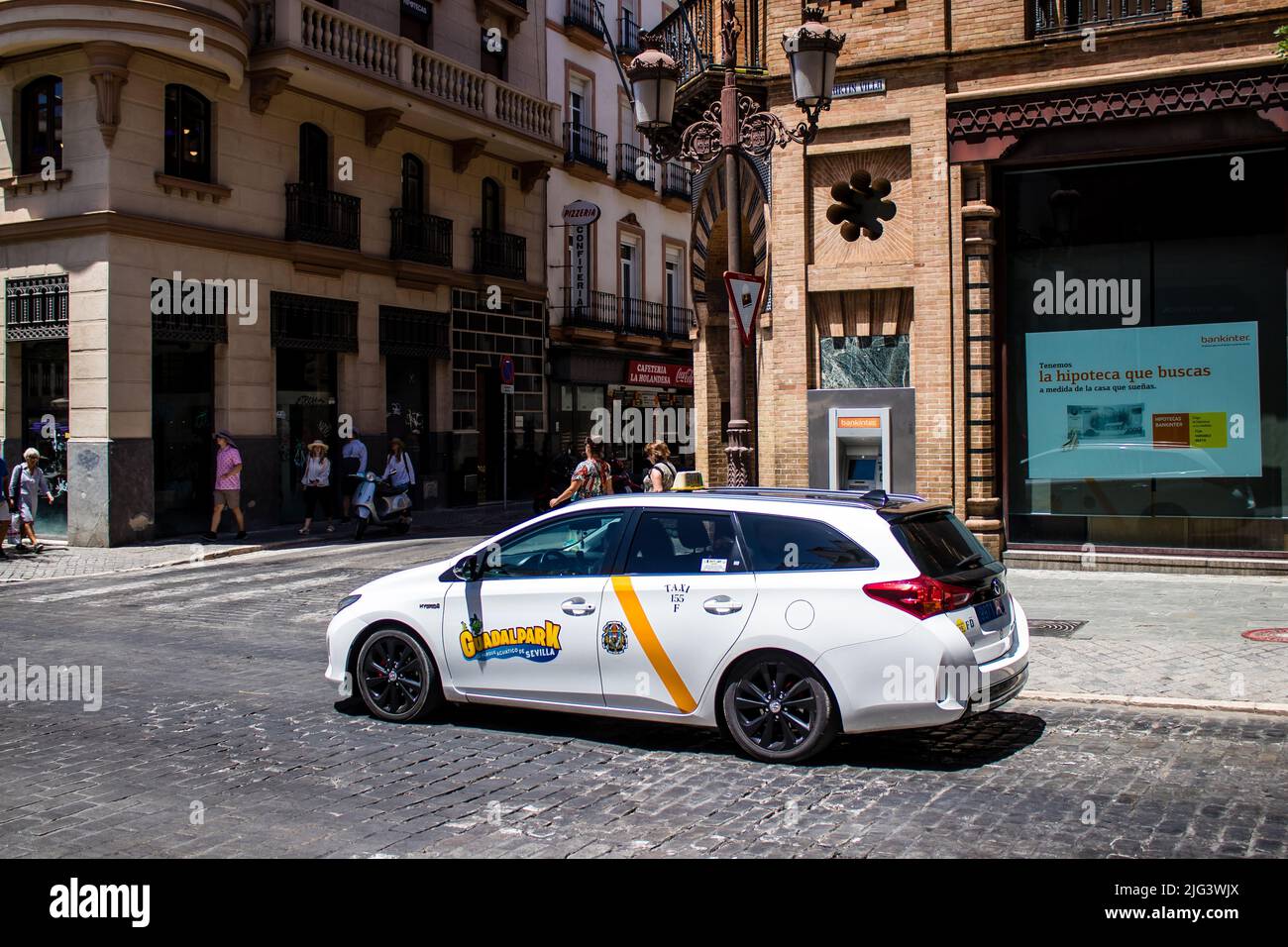 Seville, Spain July 04, 2022 Taxi driving through the streets of