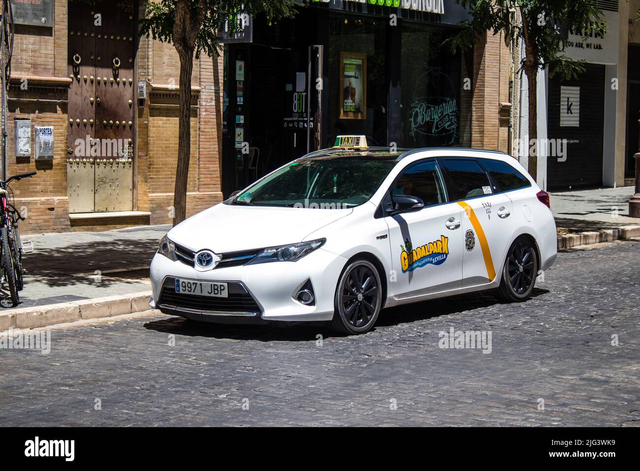 Seville, Spain July 04, 2022 Taxi driving through the streets of