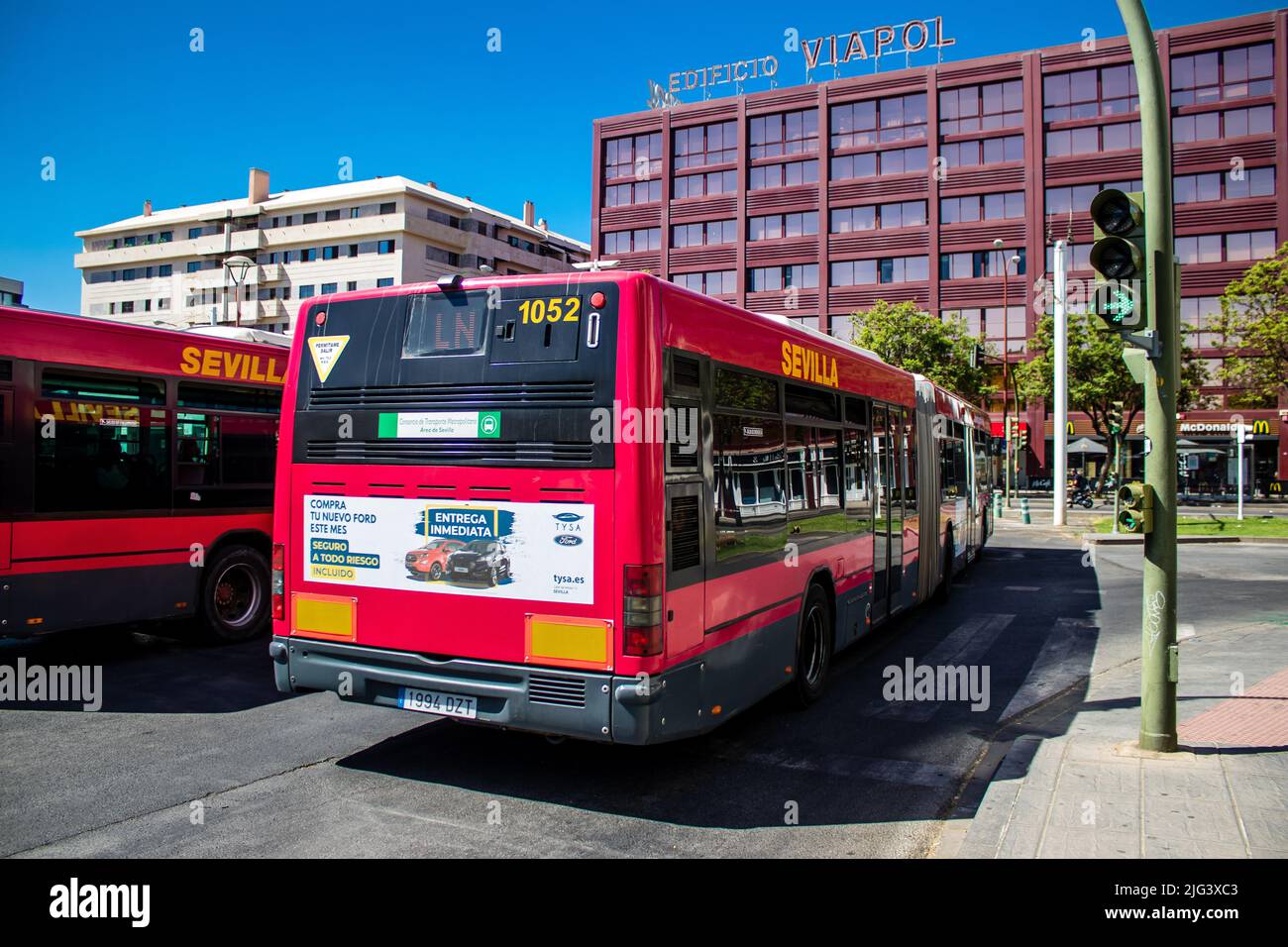 Seville, Spain July 04, 2022 Bus driving through the streets of
