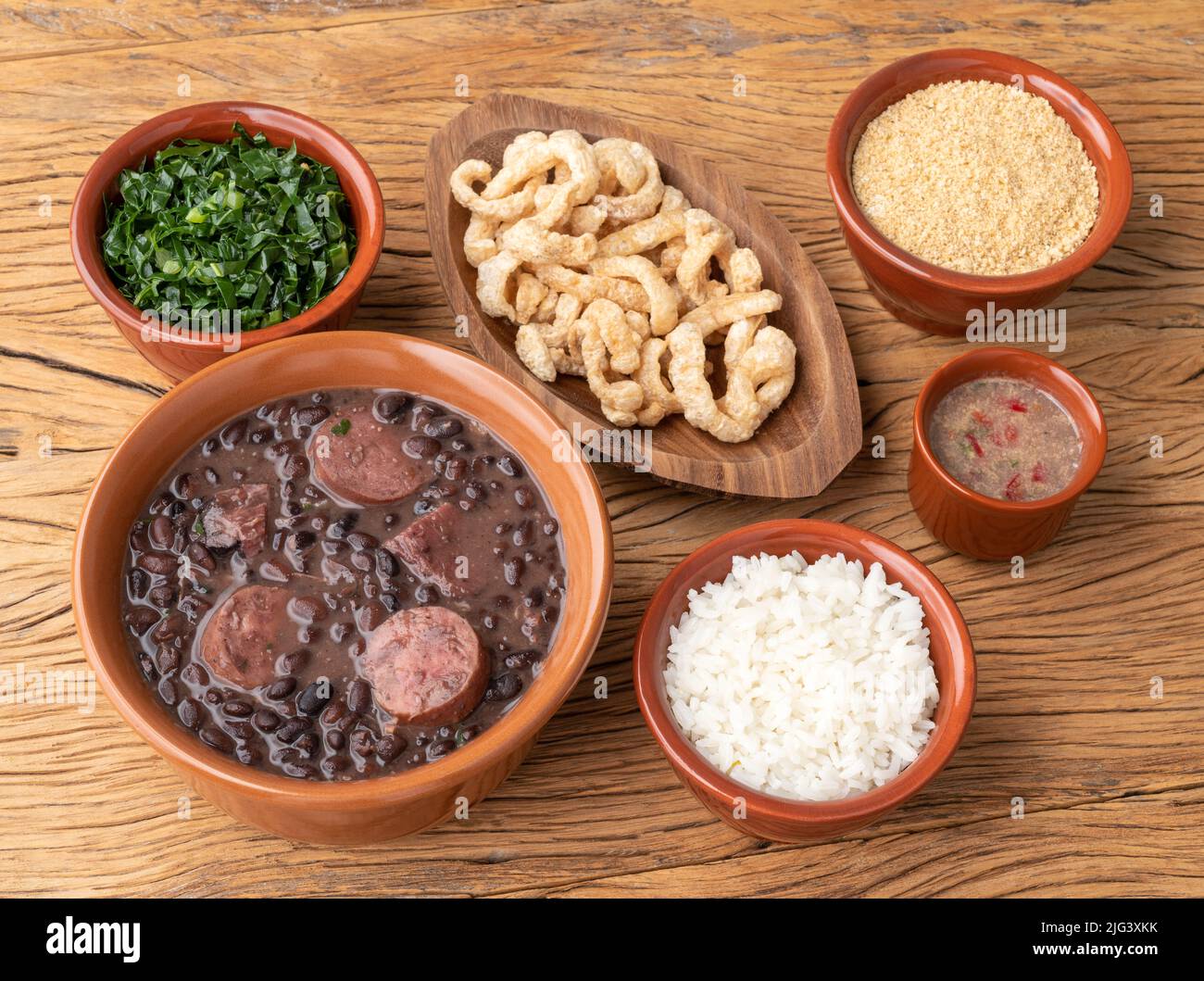 Typical brazilian feijoada with kale, rice, farofa, cracklings and