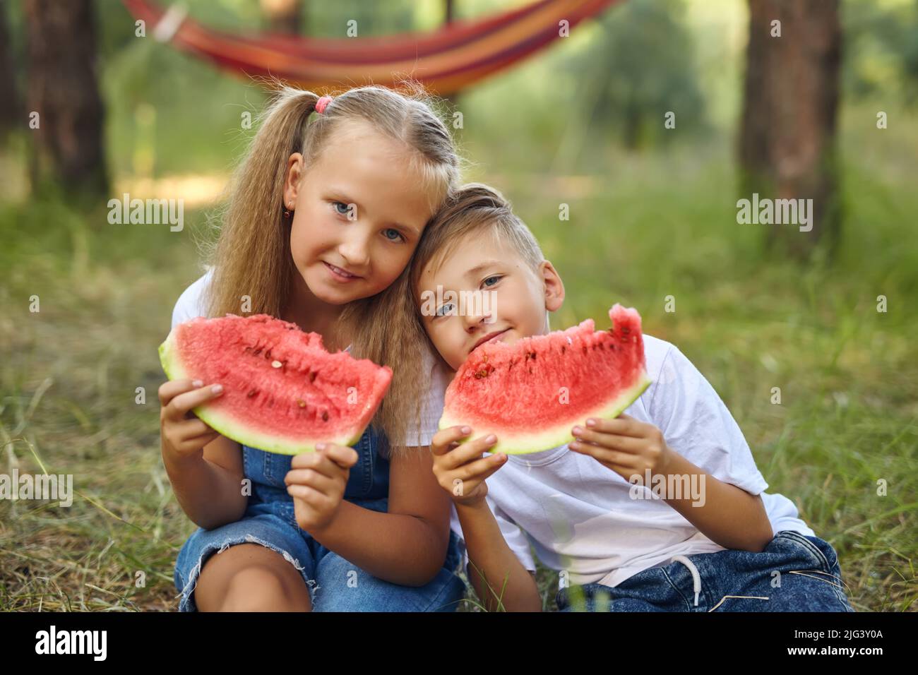 Cute kids eating watermelon in the garden. Stock Photo