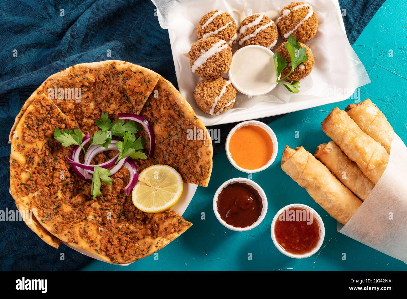 Traditional Mediterranean Moroccan pizza flatbread topped with red lentils, falafel and cheese