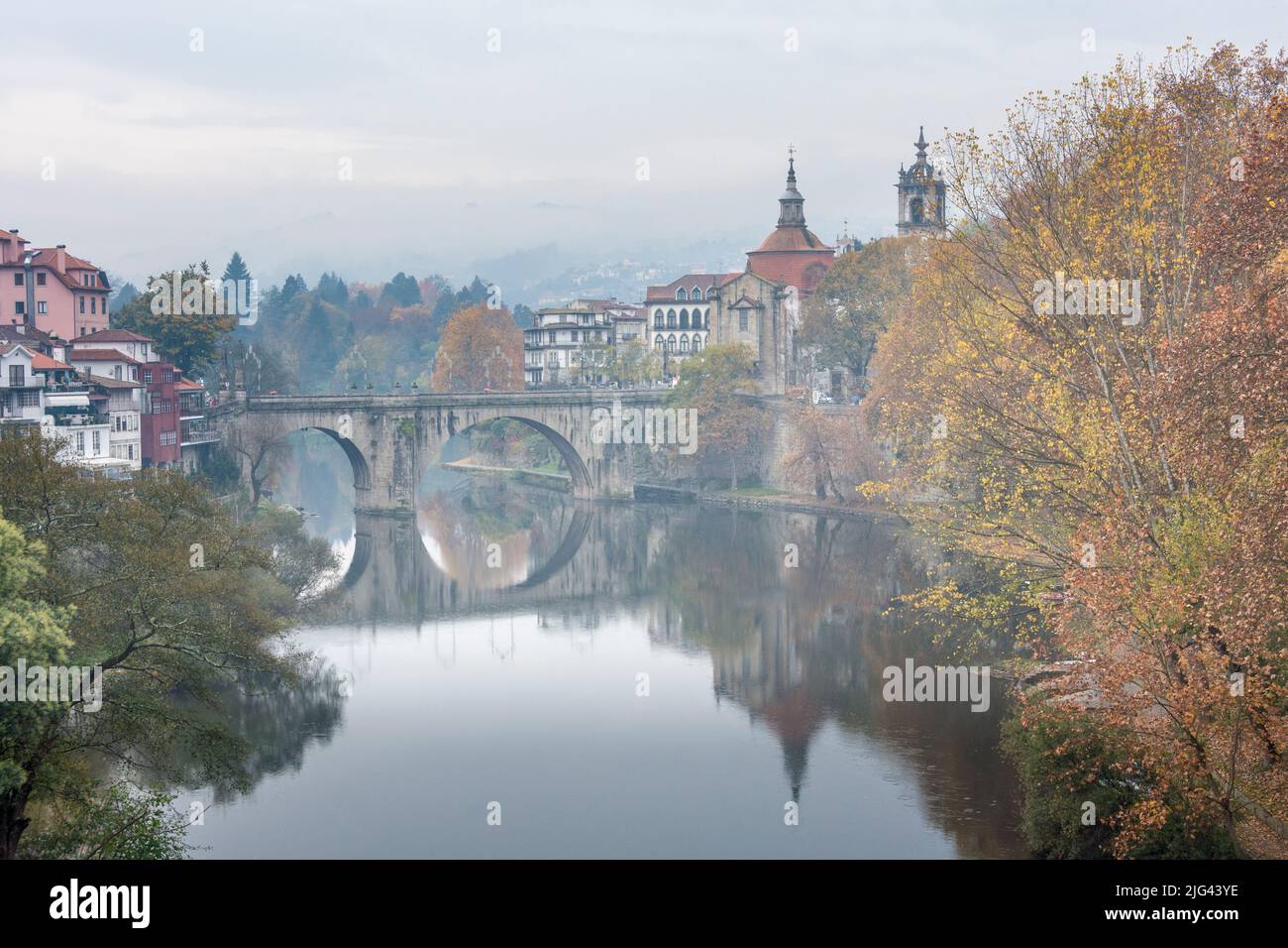 Tamega river with the historic bridge and Monastery and church of São Gonçalo in autumn. Amarante, Portugal. Stock Photo