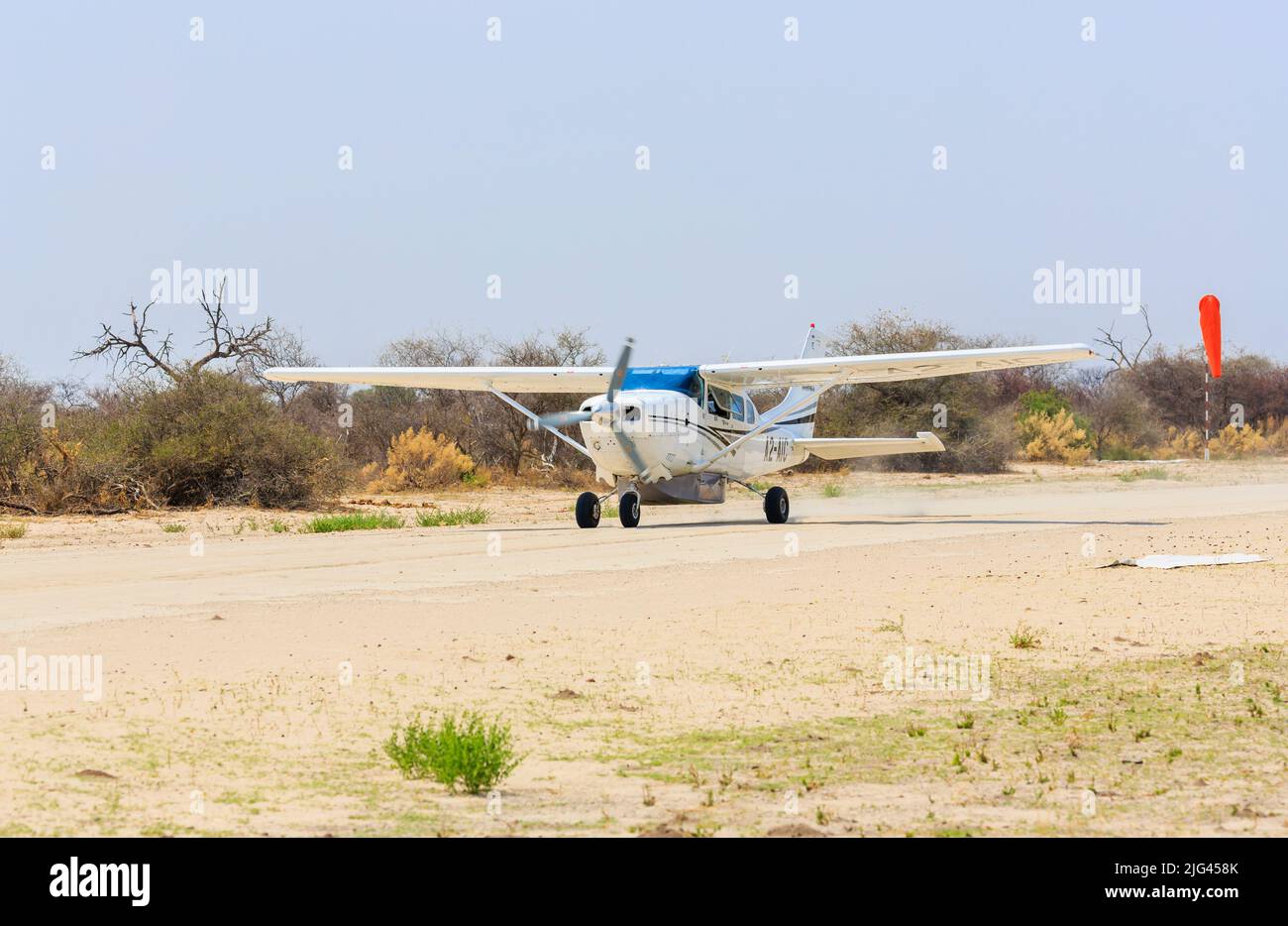A Cessna 172 on the Chitabe Airstrip serving Sandibe Camp, adjacent to the Moremi Game Reserve, Okavango Delta, Botswana, southern Africa Stock Photo