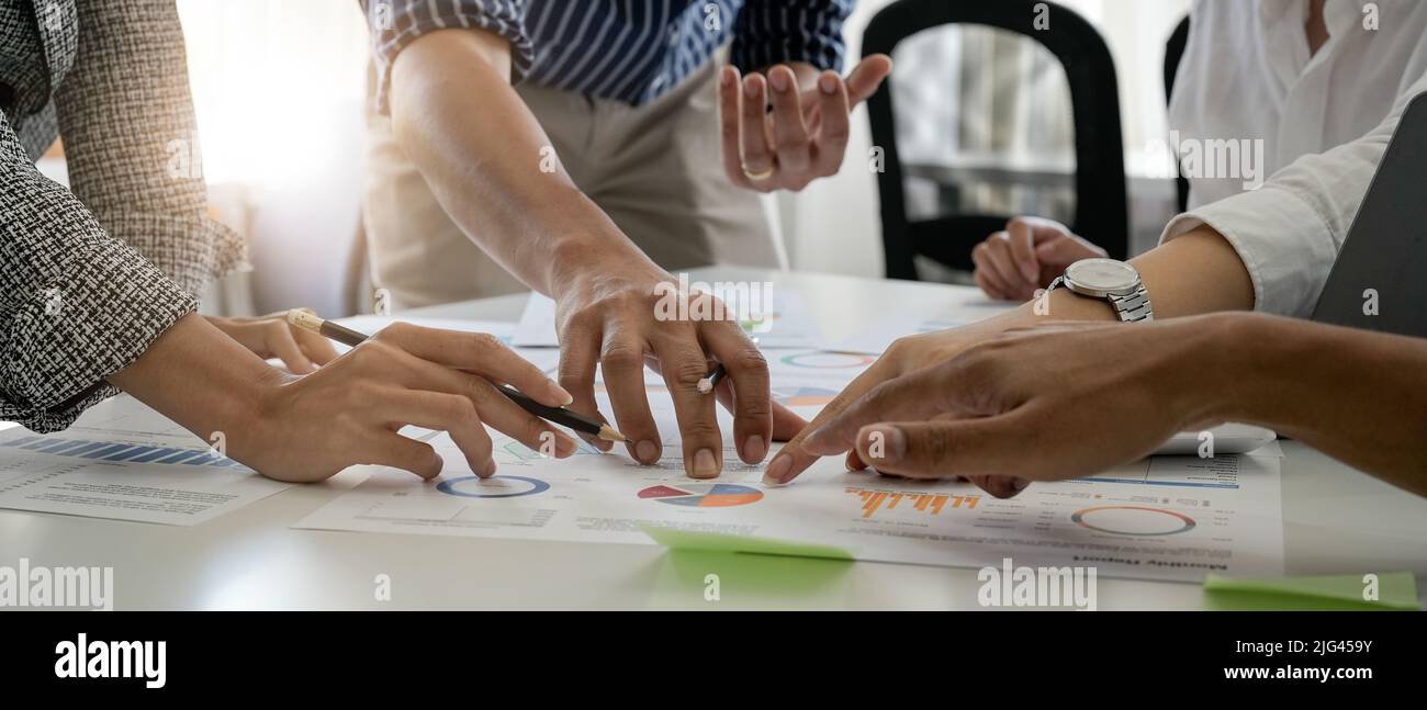 Businesspeople analyzing investment graph meeting brainstorming and discussing plan in meeting room, investment concept Stock Photo