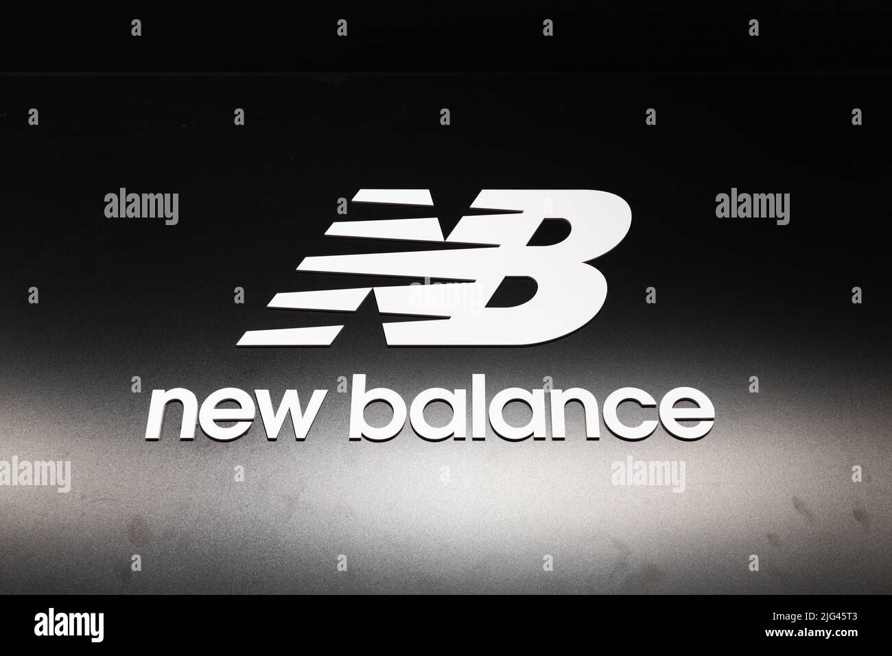 New Balance logotype logo sign on the wall of the store. Kaunas, Lithuania, 22 June 2022 Stock Photo