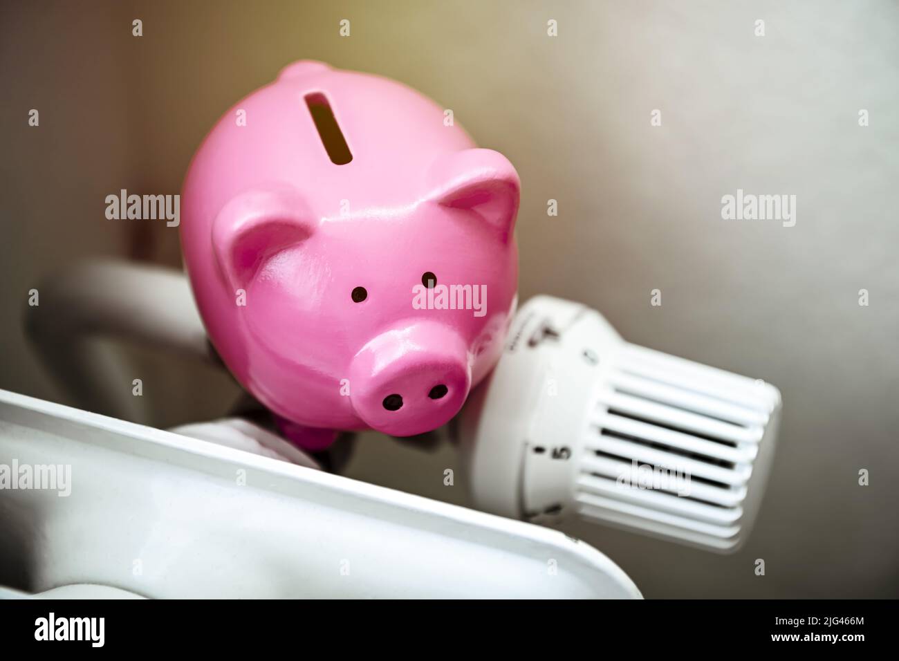 Piggy bank on a radiator Stock Photo