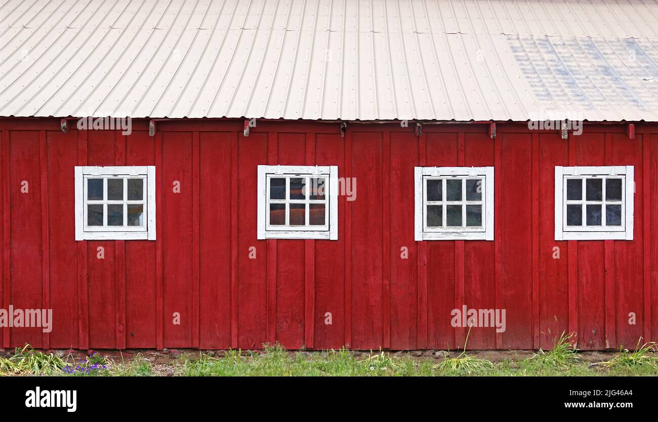 The side of an old red wooden barn on a farm near Tumalo, Oregon. Stock Photo