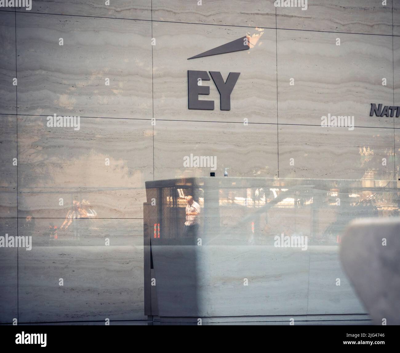 The logo of the accounting firm Ernst & Young (EY) is seen on the wall of the lobby of Brookfield’s Manhattan West office building in Hudson Yards in New York on Wednesday, June 29, 2022. EY has been fined $100 million by the SEC after it was discovered that some of its employees had cheated on their CPA exams. The cheating stretches back several years and EY was cognizant of it but did not take any action. (© Richard B. Levine) Stock Photo