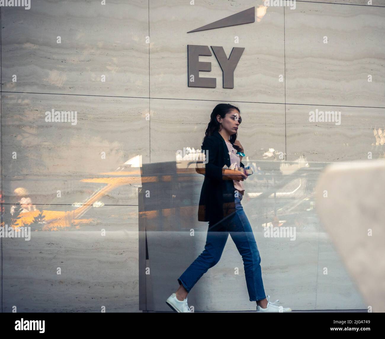 The logo of the accounting firm Ernst & Young (EY) is seen on the wall of the lobby of Brookfield’s Manhattan West office building in Hudson Yards in New York on Wednesday, June 29, 2022. EY has been fined $100 million by the SEC after it was discovered that some of its employees had cheated on their CPA exams. The cheating stretches back several years and EY was cognizant of it but did not take any action. (© Richard B. Levine) Stock Photo