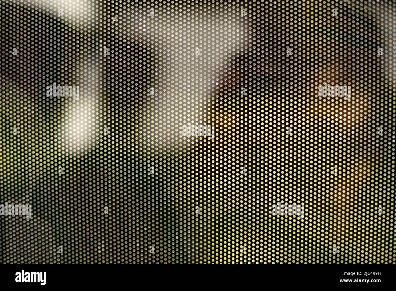 Mesh texture on glass. Shooting window. Small cage. Textured surface. Stock Photo