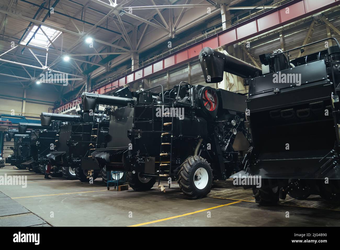 Factory hangar with combine harvesters assembled. Industrial production of agricultural machinery. Stock Photo
