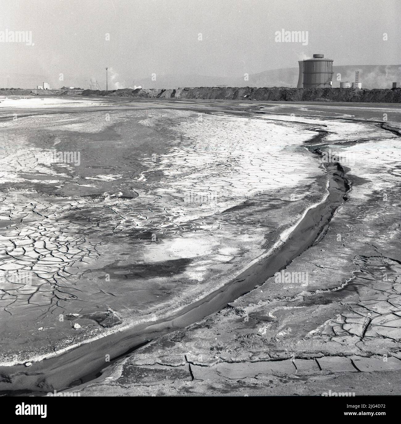 1950s, historical view of Baglan Bay and on the right large earthworks at  the steelworks at Port Talbot, Wales, UK. Baglan Bay is part of the Swansea  Bay coastline Stock Photo -
