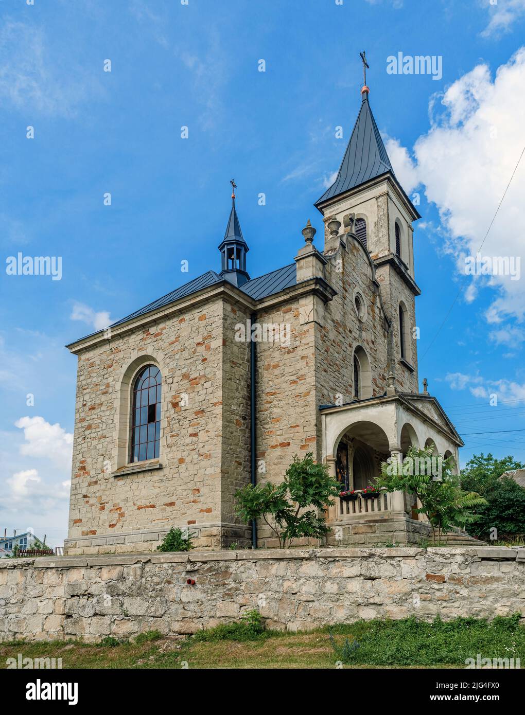 Cloudy landscape with stone church. Catholic church on background of ...