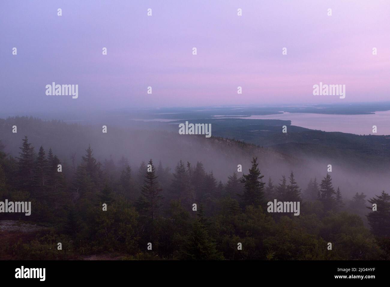 Foggy Landscape at Sunrise with Bar Harbor, Maine, USA in Distance Stock Photo