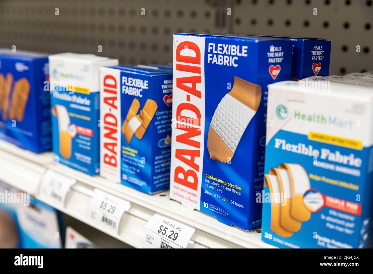 boxes of Band-Aid brand bandages sit on a drug store shelf Stock Photo