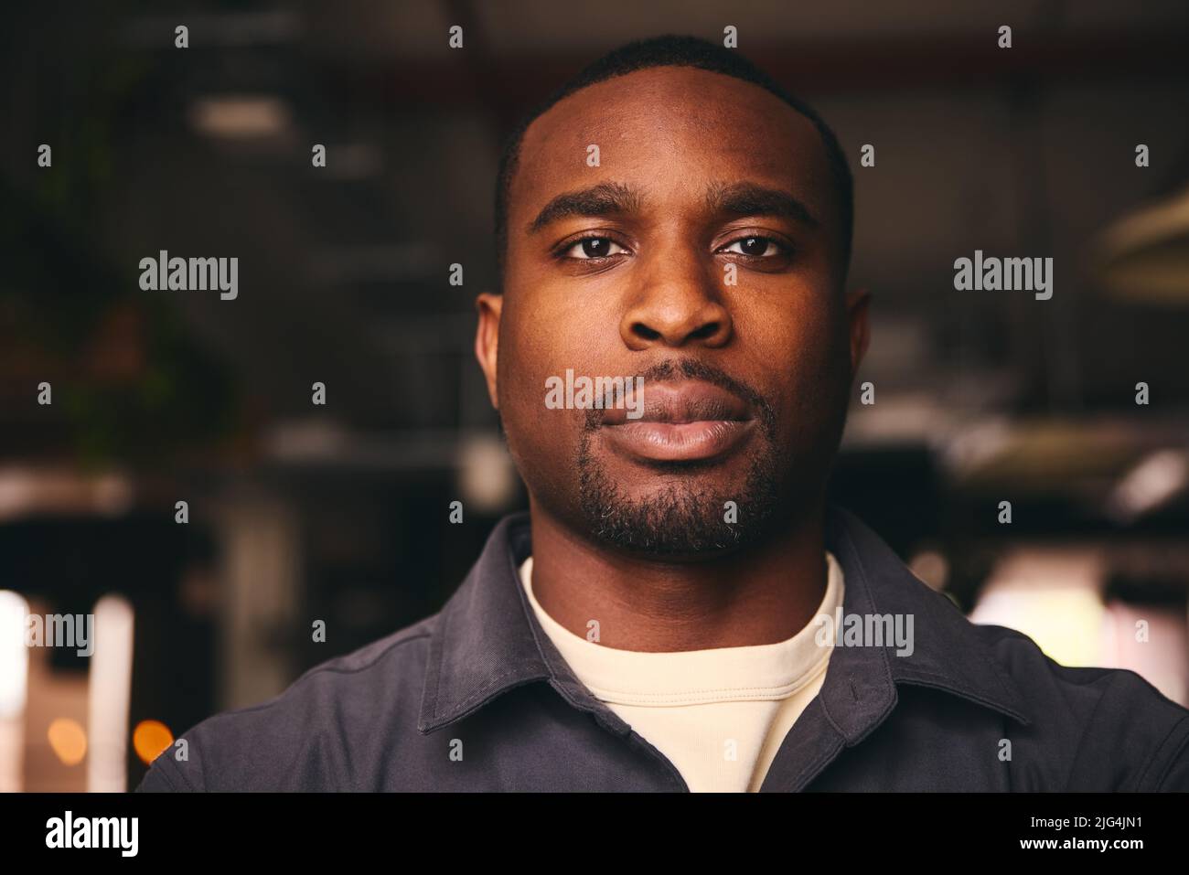 Confident Young Black Male Standing In Office Looking At Camera Stock Photo