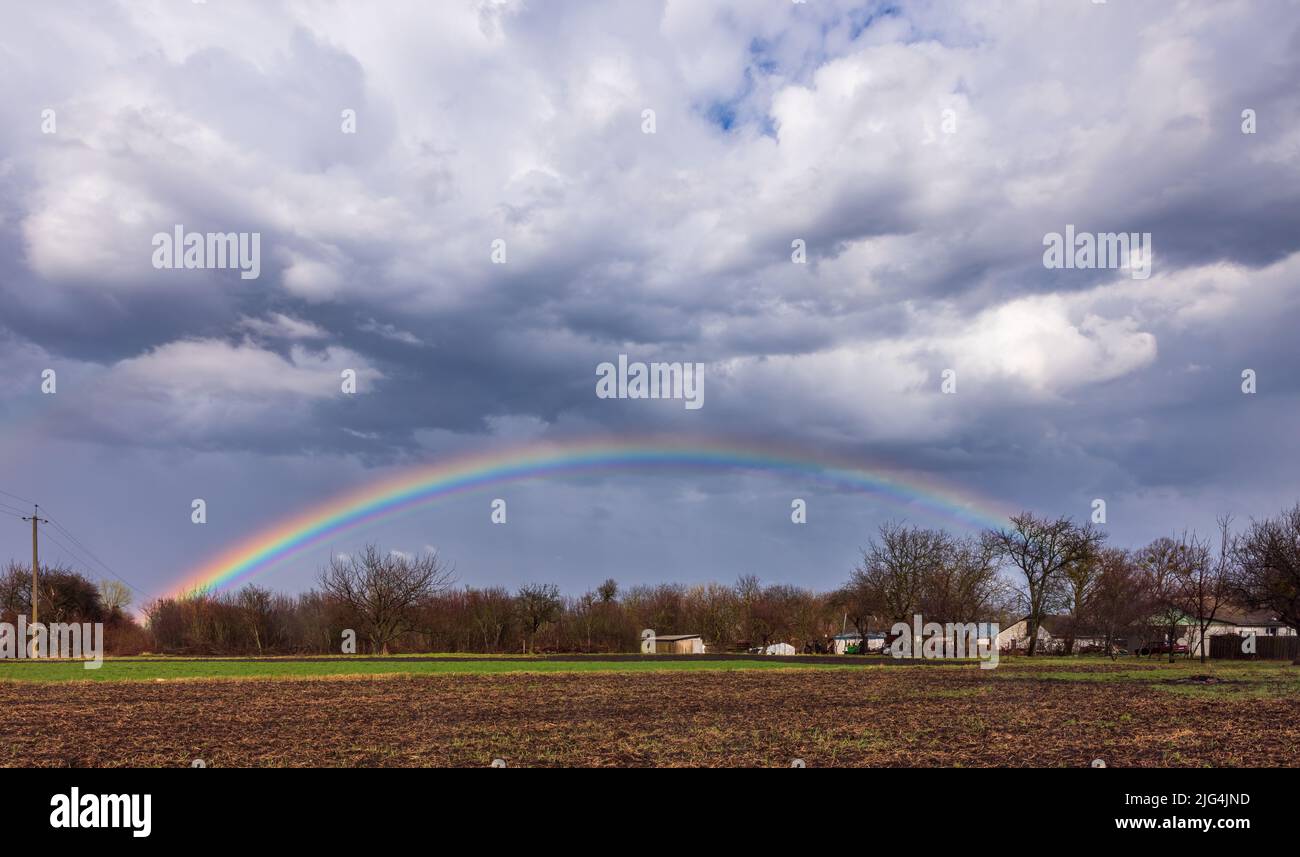 Rainbow in blue sky with white clouds hi-res stock photography and ...