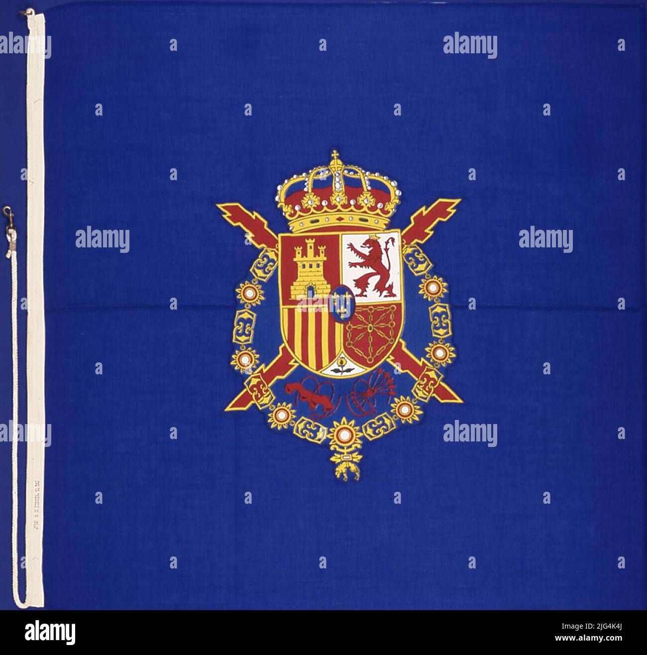 Royal S.M. King Juan Carlos I. banner. Go on December 11, 1991 at the Prince of Asturias aircraft carrier during a navigation with S.M. The king aboard. She entered the Naval Museum on 8-1-1997 with a blue background, in the center it has a quarter shield of the blazons of Castilla, León, Aragón, Navarra and, bound in Punta, Granada. In El Escusón, three lis flowers of Bourbon's house. Acolada to the shield, the Red Cross of Burgundy, and to the left and right of the tip of the shield, the yoke in its natural position and the beam of five arrows with tips down. All surrounded by the gold toiso Stock Photo