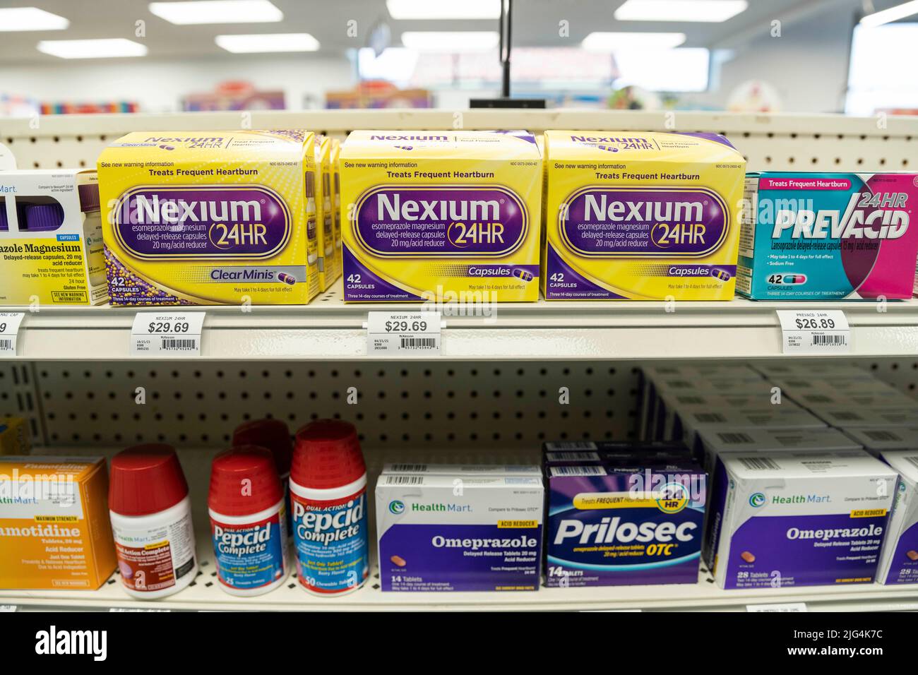 Boxes of Nexium, Prilosec, and Pepcid brand heartburn medication sit on the shelves of a drug store Stock Photo