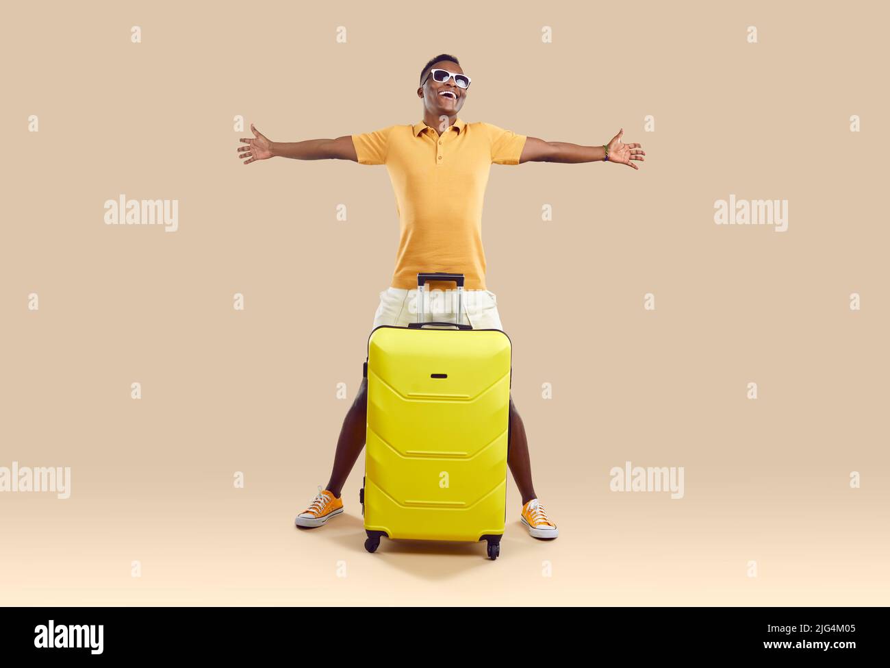 Overjoyed biracial man with suitcase ready for vacation Stock Photo